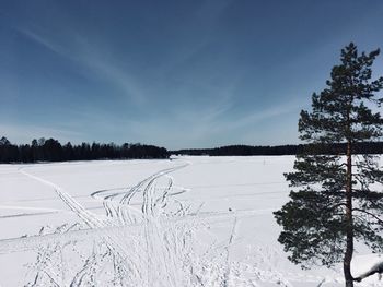 Snow covered field against sky
