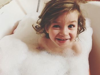 High angle view of toddler enjoying in bathtub