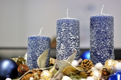 Close-up of candles by christmas decoration