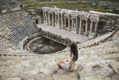 Woman sitting at amphitheater