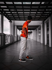 Man standing in corridor of building