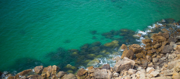 High angle view of rocks in sea