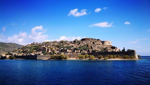 Scenic view of sea and buildings against sky