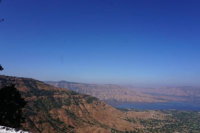 Scenic view of mountains against clear blue sky