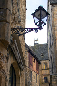 Low angle view of street light against building