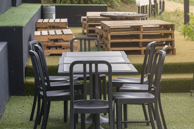 Empty chairs and table in park