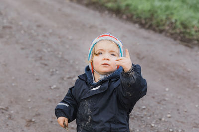 Innocent girl standing on dirt road