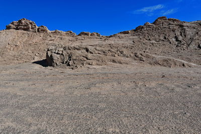 Rock formations on landscape against sky