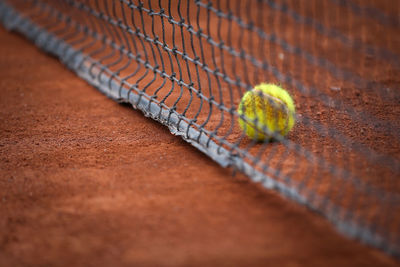 High angle view of tennis ball and net on field