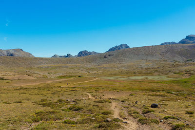 Scenic view of mountains against clear blue sky