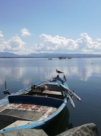 Boat moored in sea against sky