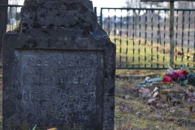 Close-up of metal fence at cemetery