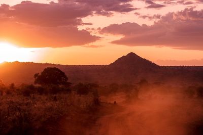 Scenic view of silhouette mountains against sky at sunset