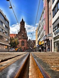Surface level of railroad tracks by buildings in city