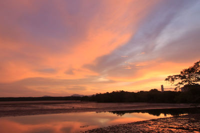 Scenic view of lake against romantic sky at sunset