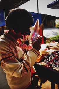 Souvenir seller smoking at market