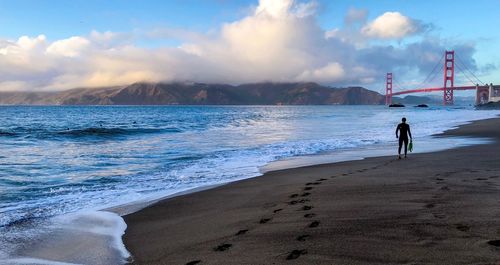 People on beach against sky