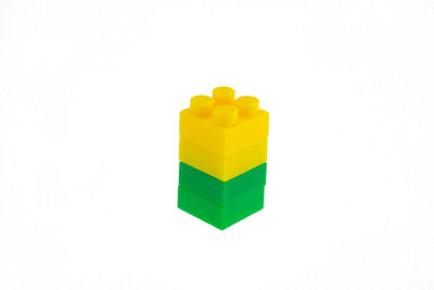 High angle view of yellow toy against white background