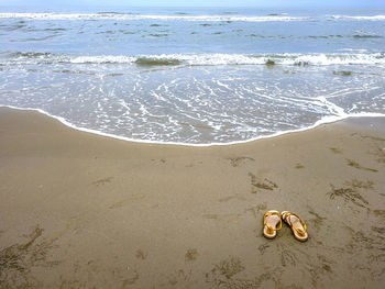 High angle view of shoes on beach