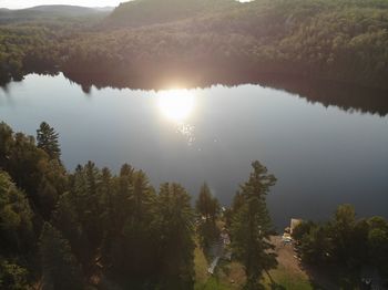 Scenic view of lake and trees against sky