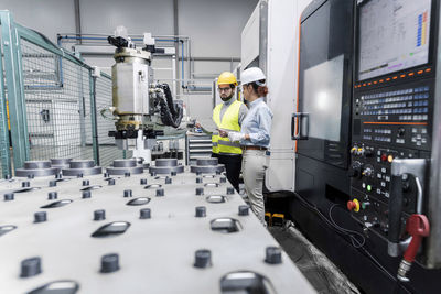 Young engineers working in factory