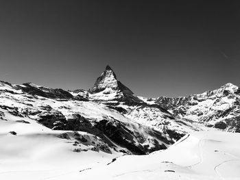 Scenic view of snowcapped mountains against clear sky