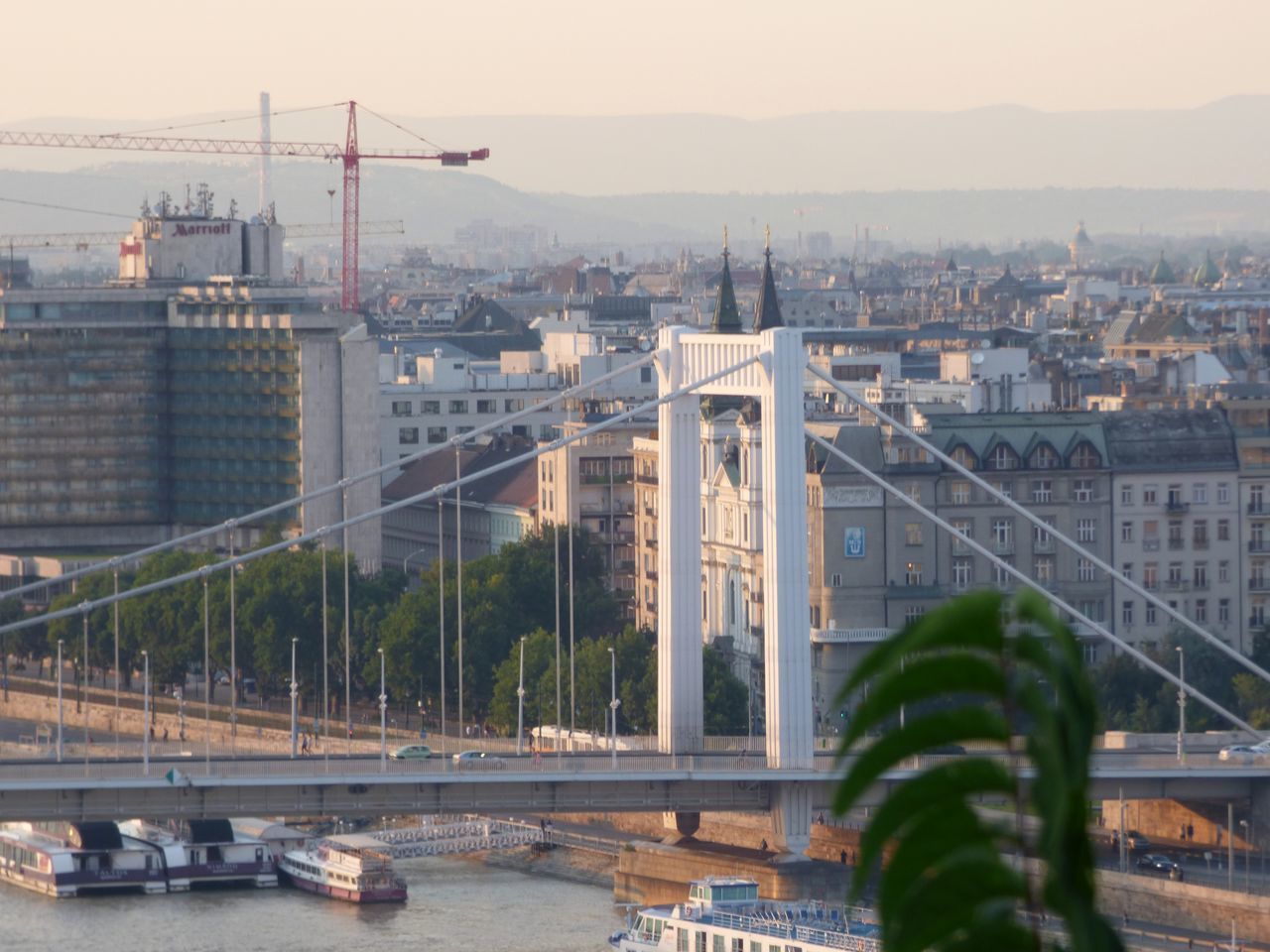 HIGH ANGLE VIEW OF BRIDGE OVER RIVER BY BUILDINGS AGAINST SKY