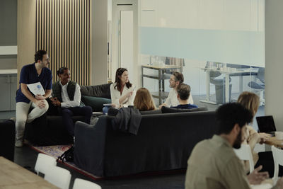 Group of business people having meeting in lobby