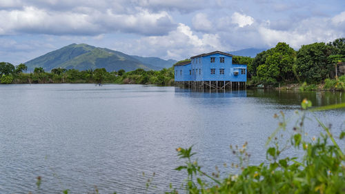 Scenic view of lake and buildings against sky