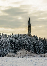 Tower and trees against sky