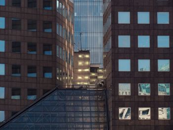 Low angle view of modern glass building in city