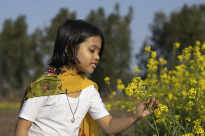 Close-up of woman holding red flowering plants