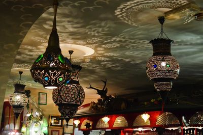 Low angle view of illuminated lanterns hanging in city at night