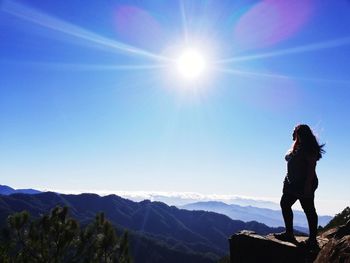 Man looking at mountains on sunny day