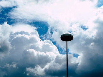 Low angle view of street light against cloudy sky