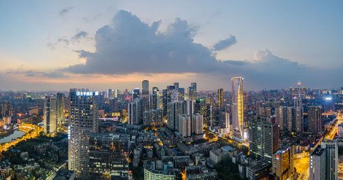 Low angle view of city lit up at night