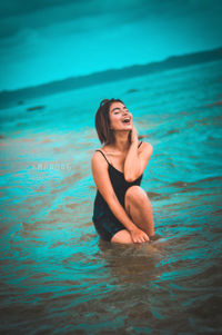 Young woman smiling in swimming pool