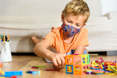 Boy playing with toy at home