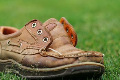 Close-up of leather shoe on grassy field