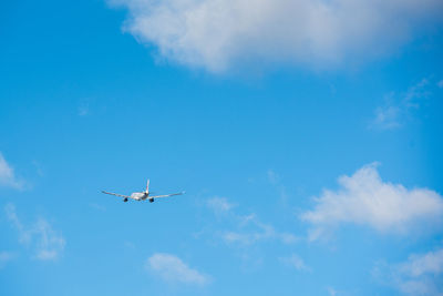 Low angle view of airplane flying in sky