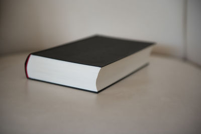 Close-up of open book on table at home