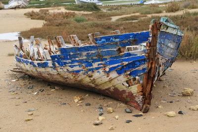 Abandoned boats moored on shore