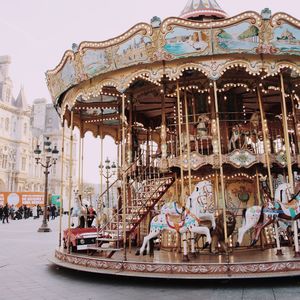 Carousel in amusement park against clear sky