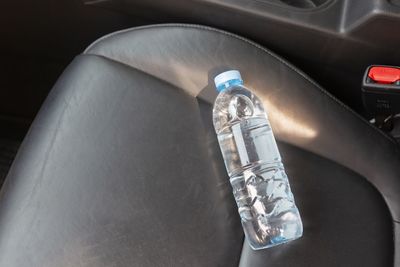 High angle view of bottle on car windshield