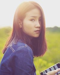 Portrait of young woman against clear sky