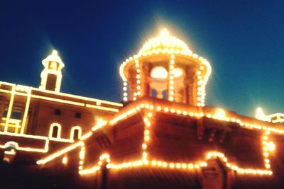 Low angle view of illuminated building at night