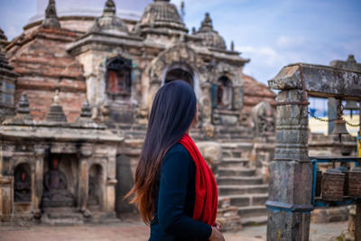 Rear view of woman looking at historical building