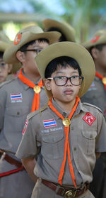 Portrait of boy scout standing outdoors at school,thailand.