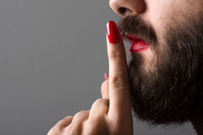 Close-up of woman hand against red background