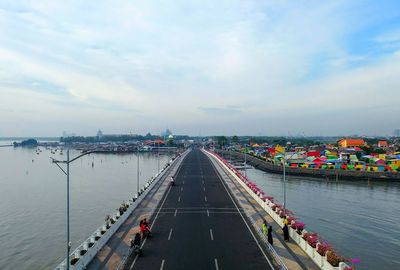 High angle view of bridge over river in city against sky